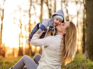 Young mother kissing baby