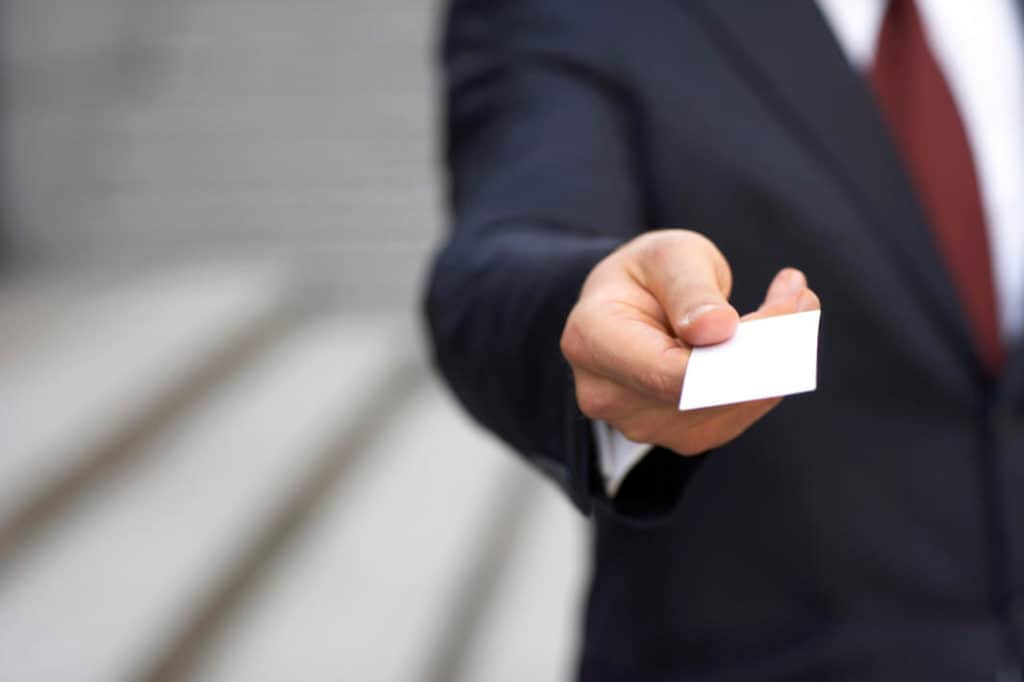 man handing over a business card
