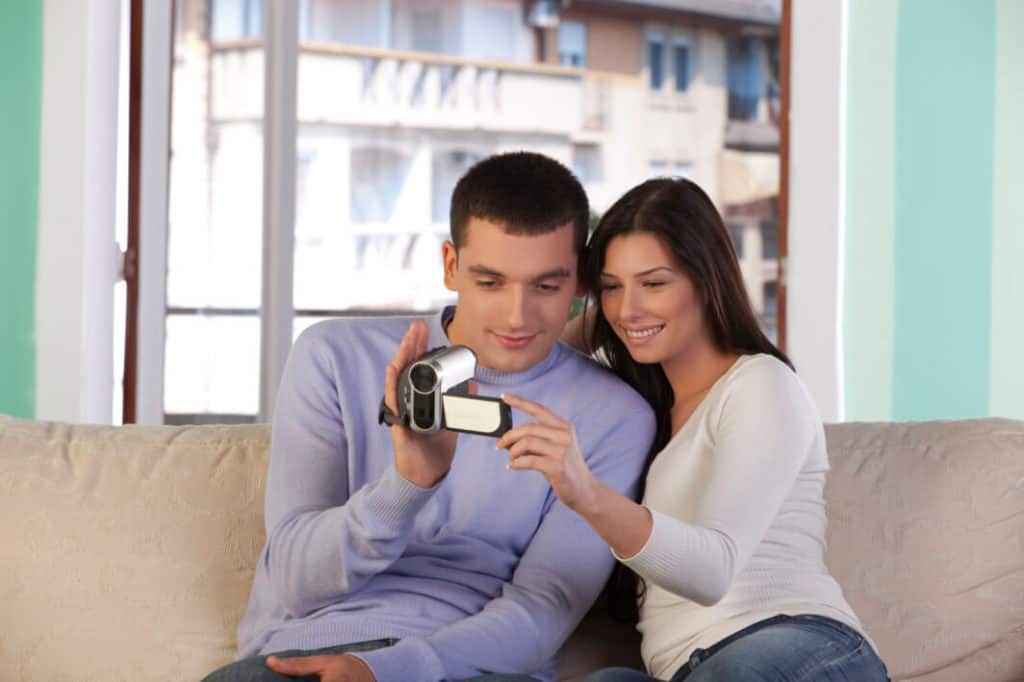 Couple operating a video camera