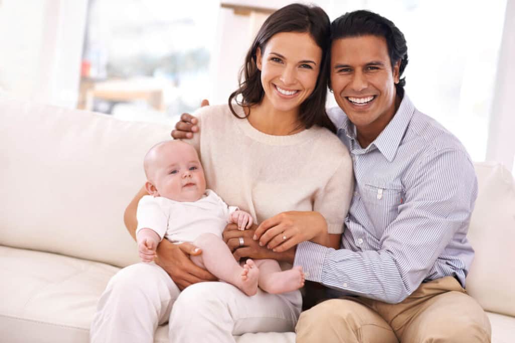 Happy couple holding a baby boy