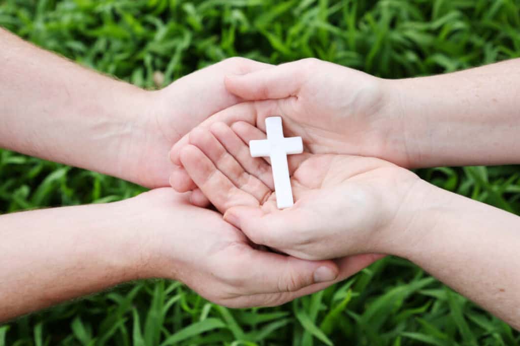 Hands holding a cross