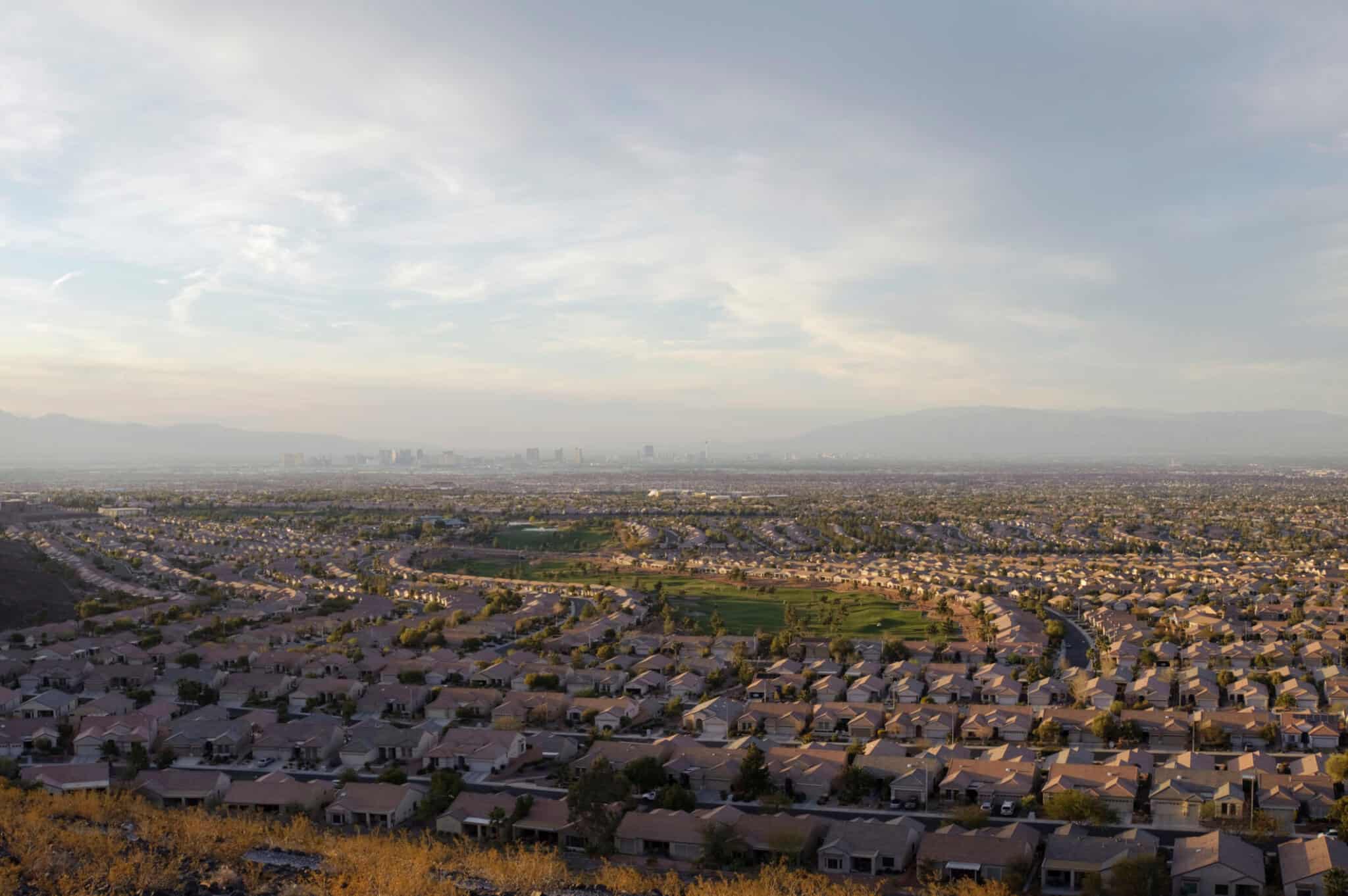 Wide angle image of the Vegas Valley from the Seven Hills planned community at the southeast side. The Las Vegas strip and downtown hotel / casinos are visible through the afternoon haze.