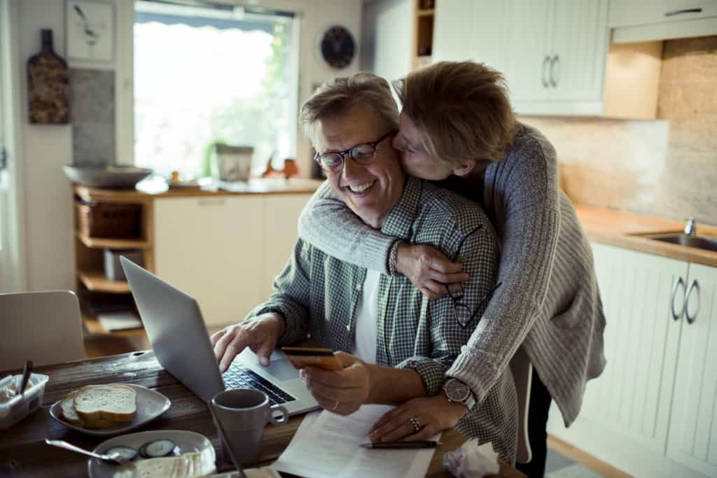 Close up of a mature couple using the computer in the morning