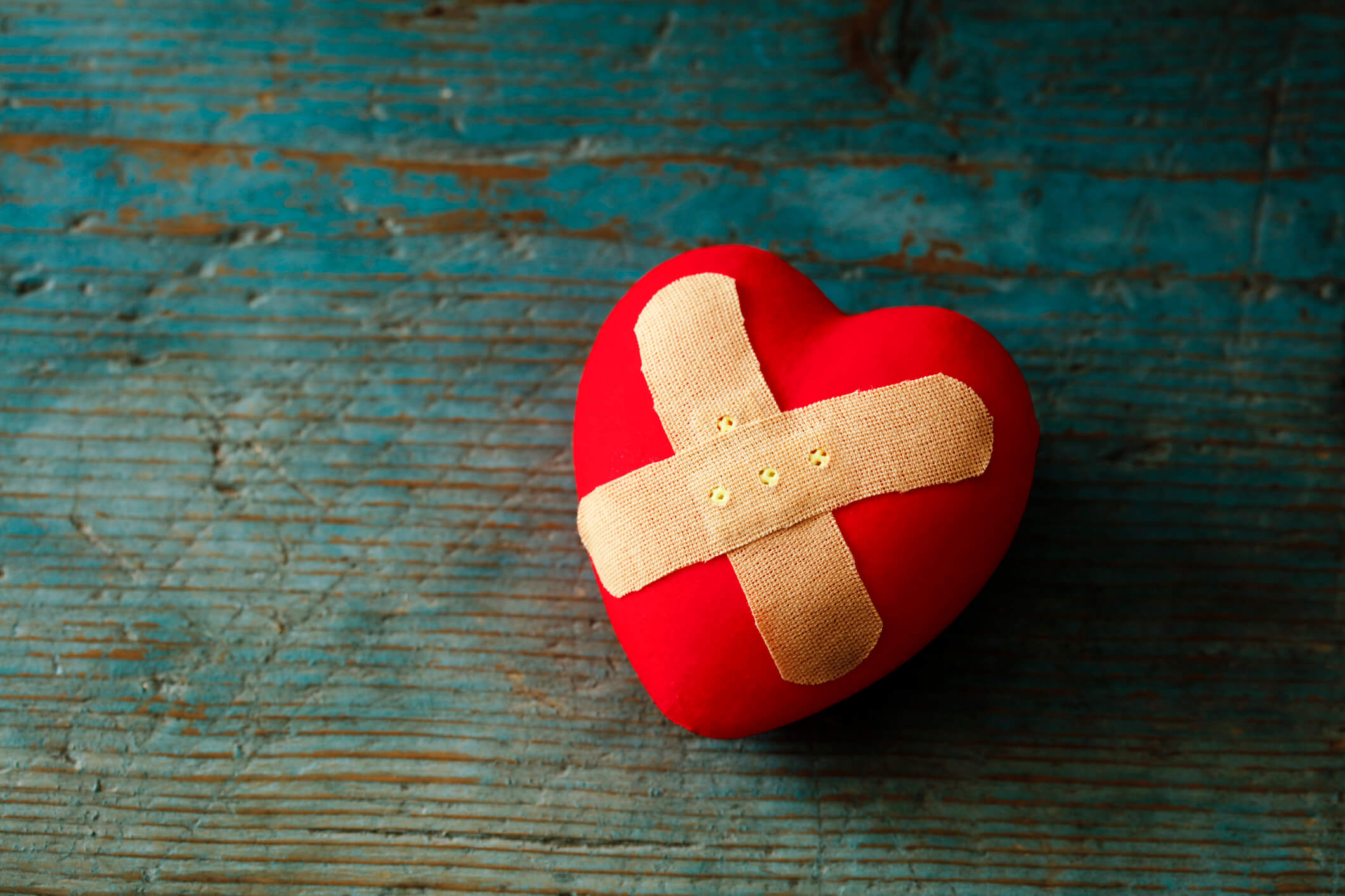 A red heart with a Band-Aid on it